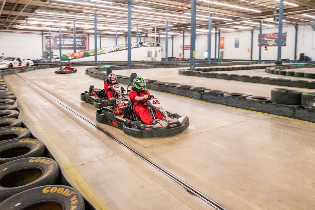 Group of kids celebrating a birthday at an indoor go-kart track